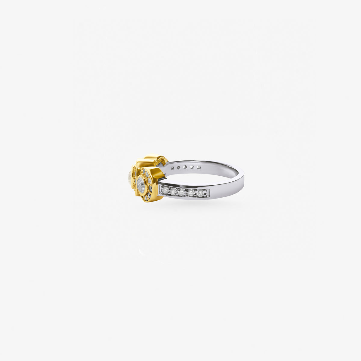 Peter Marco 18k two-tone white and yellow gold bezel set round cut diamond three-stone ring, side view