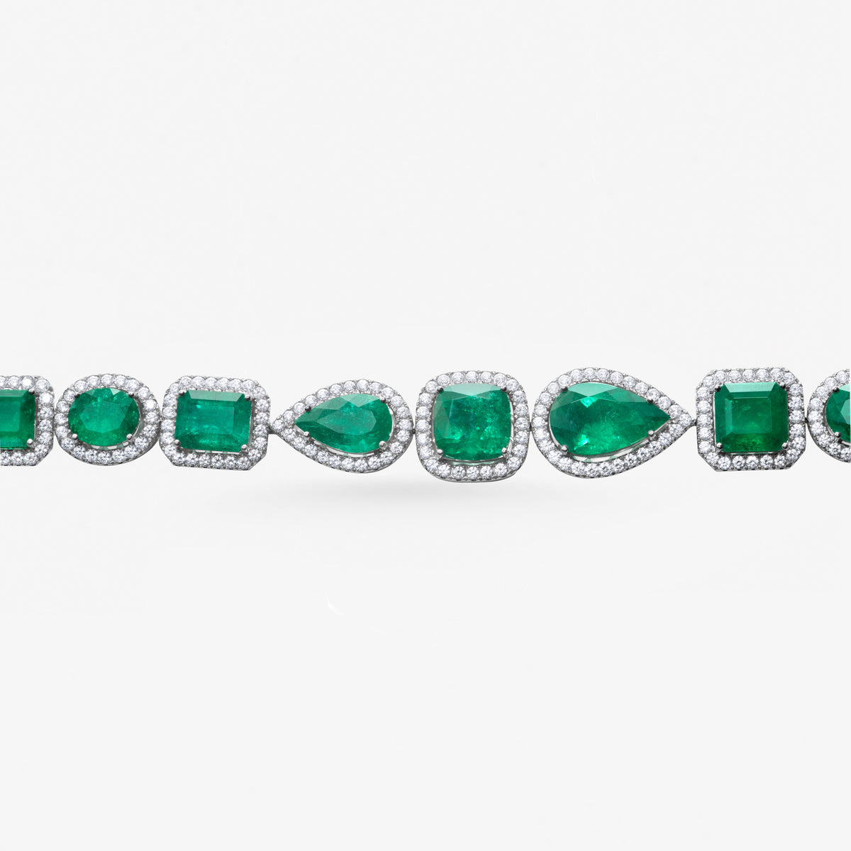 Peter Marco 18k white gold pear and cushion cut emerald with round cut diamond bangle, detail view