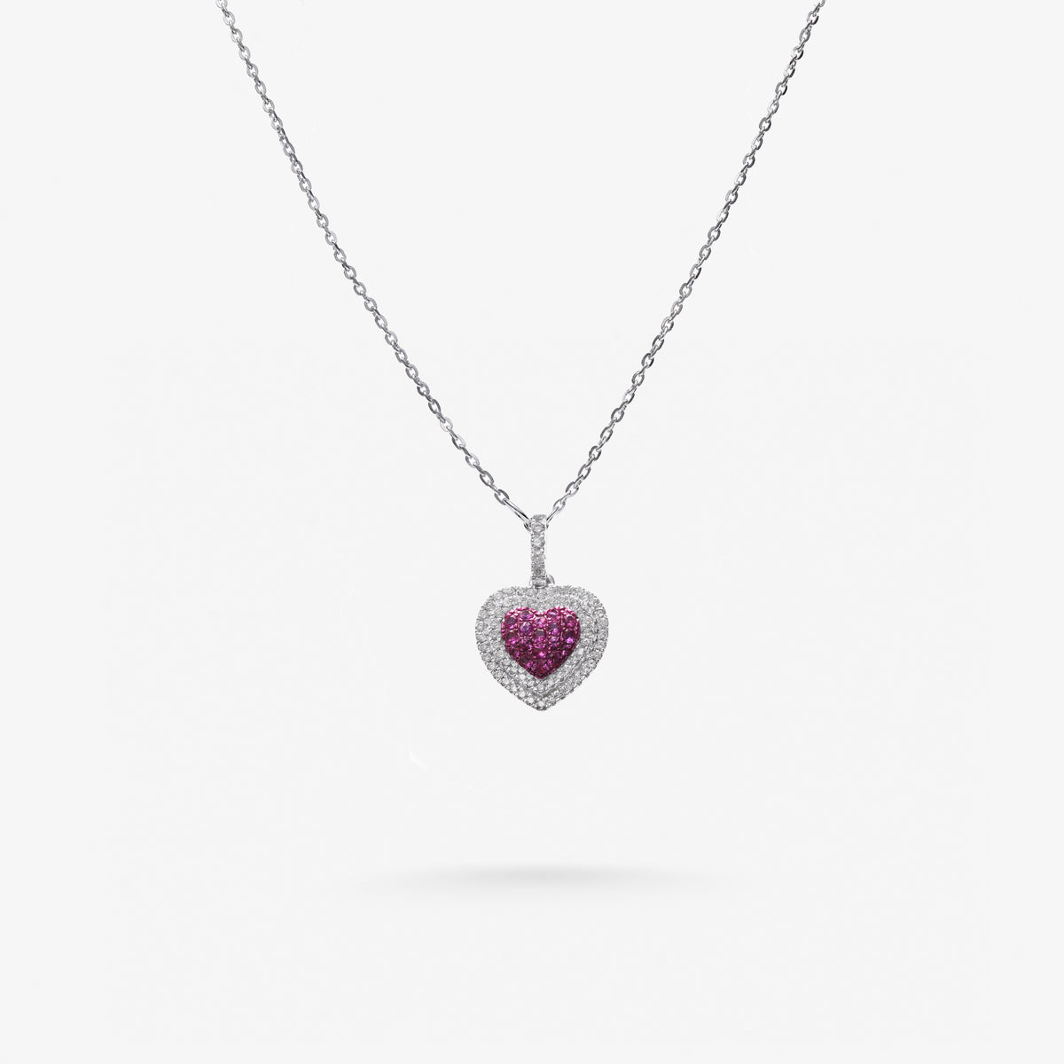 Peter Marco 18k white gold round cut diamond and pink sapphire heart pendant