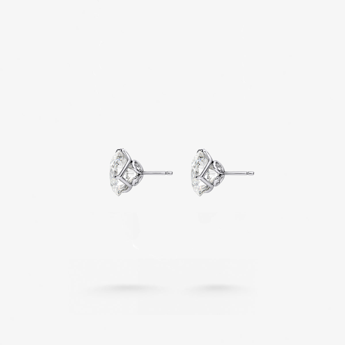 Peter Marco 18k white gold three-prong round cut diamond stud earrings, side view