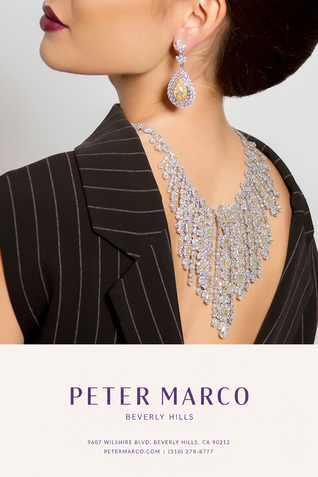 Girl wearing 18K white and yellow gold diamond necklace and matching drop earrings.
