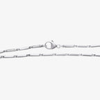 Diamond station link bracelet with rectangular white gold links and diamond-set accents near a heart-shaped clasp, 18K white gold.