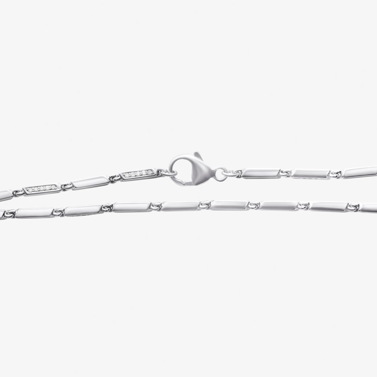 Diamond station link bracelet with rectangular white gold links and diamond-set accents near a heart-shaped clasp, 18K white gold.