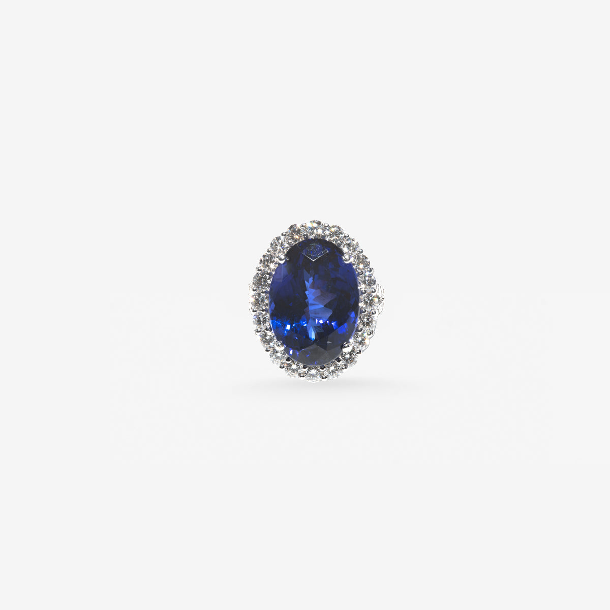 Peter Marco oval blue sapphire ring surrounded by a halo of round diamonds