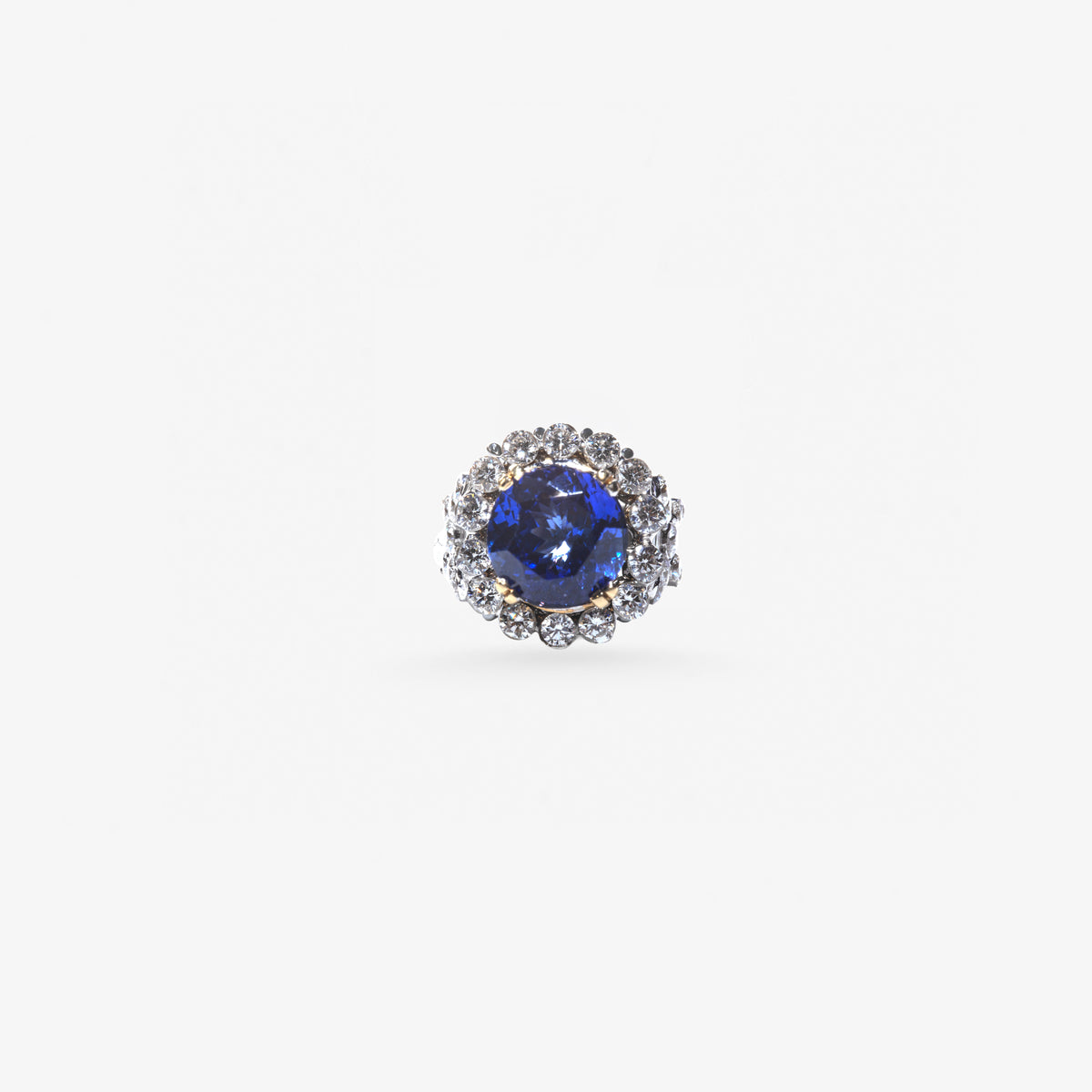 Peter Marco blue round sapphire center stone ring surrounded by a halo of round diamonds