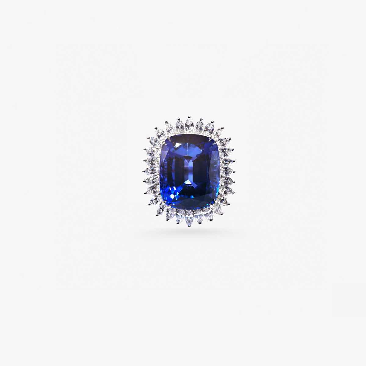 Peter Marco blue sapphire ring with a floral diamond and intricate white metal setting.