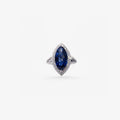 Peter Marco blue sapphire ring surrounded by a white diamond halo with diamond-set band