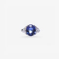 Peter Marco blue sapphire ring featuring an oval blue center gemstone with diamond accents on either side.