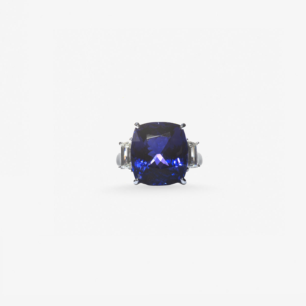 Peter Marco blue sapphire ring with diamond accents on either side of the center gemstone.