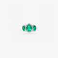 Peter Marco emerald ring featuring three green gemstones surrounded by diamond accents in a white metal setting.
