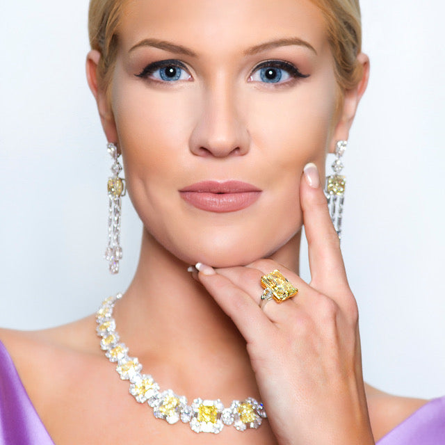 Peter Marco girl model wearing a yellow diamond necklace and yellow diamond ring with a yellow diamonds earring