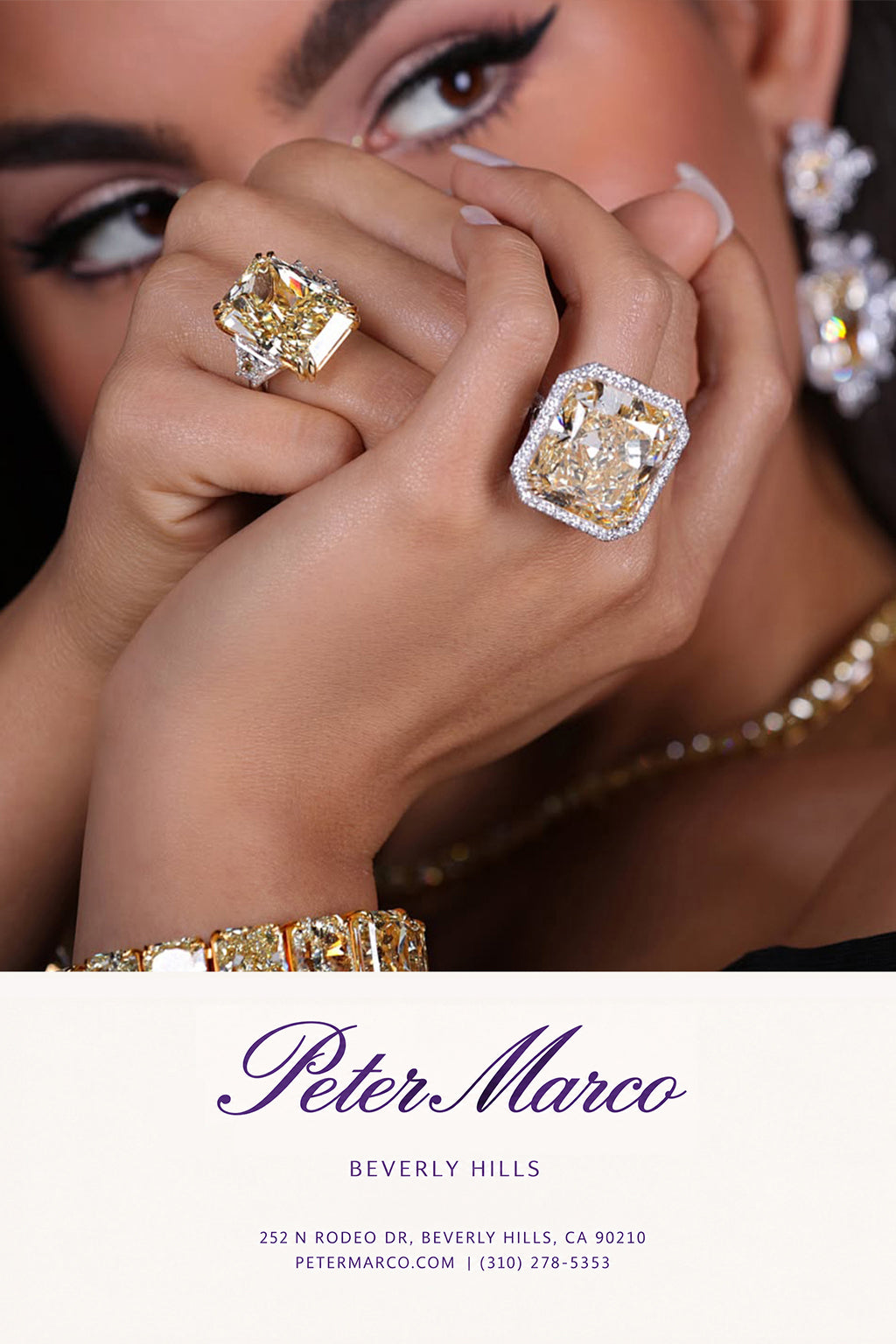 A women wearing two big yellow diamond and white diamond rings from Peter Marco