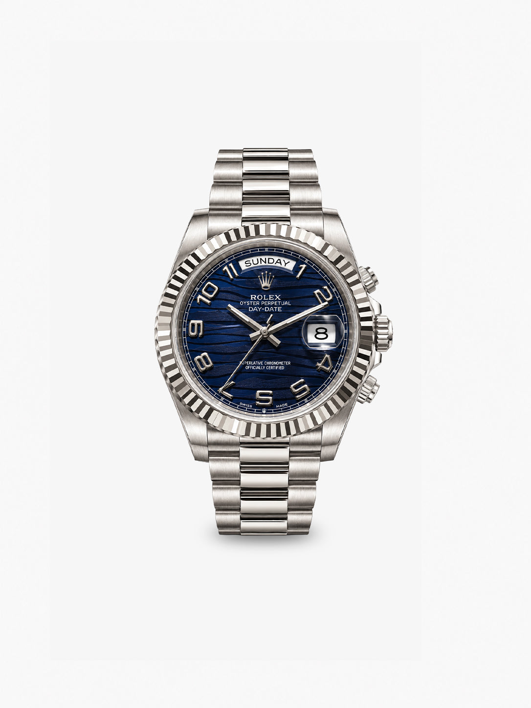 Peter Marco Rolex Day-Date watch with blue textured dial, Arabic numeral hour markers, fluted bezel, and silver-tone bracelet.