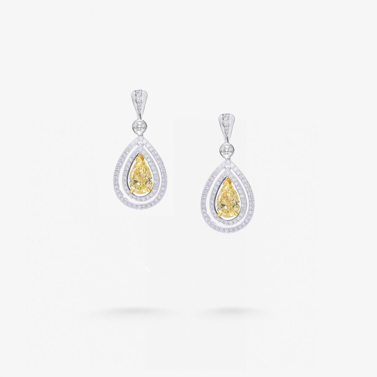 Peter Marco round cut white and pear shaped yellow diamond drop earrings